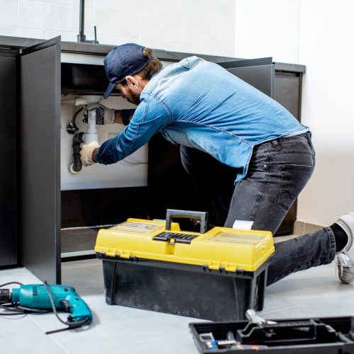 man-repairing-kitchen-furniture.jpg