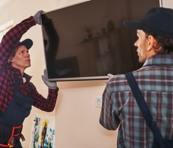 setting-plasma-television-two-technician-installing-television-kitchen_386167-10864